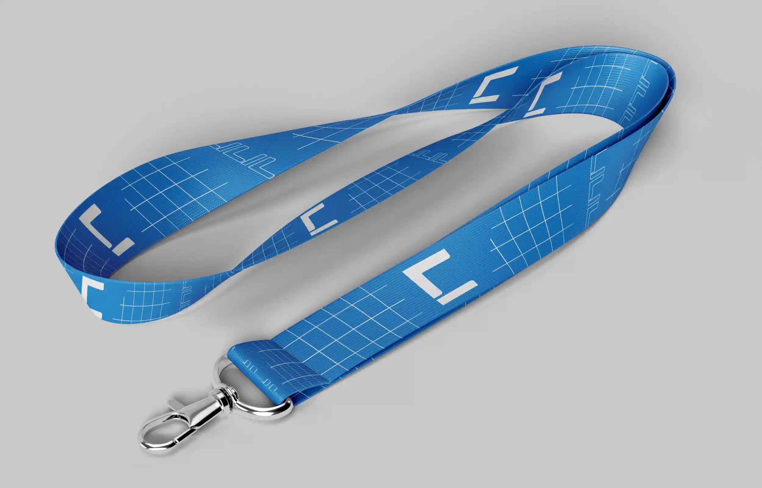 Blue lanyard with white geometric patterns and a silver metal clip on a gray background.