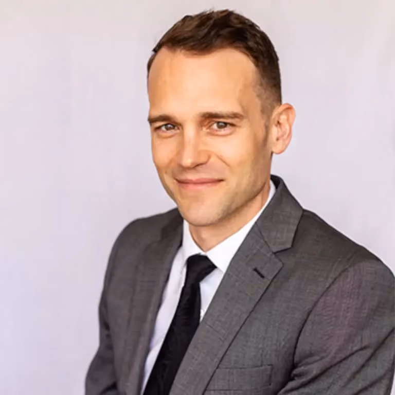 headshot of Cody J. Wagner wearing a suit and tie