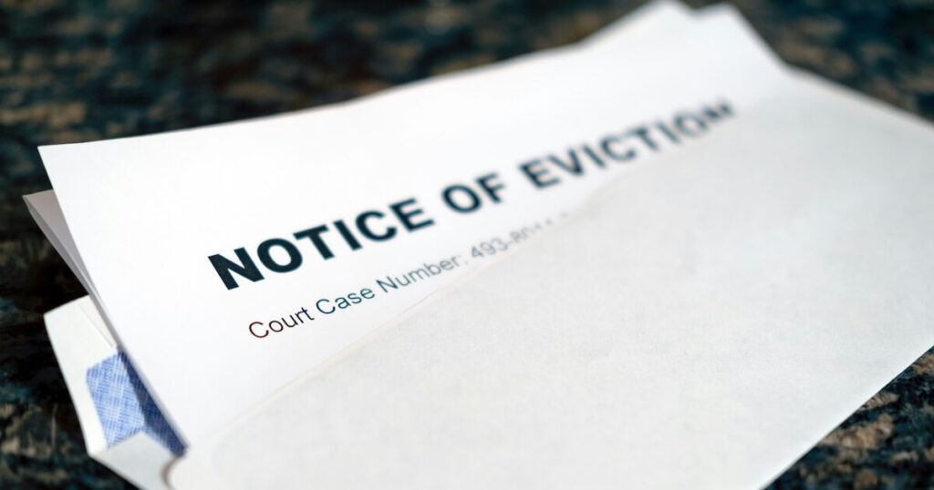 Close-up of a document titled 'Notice of Eviction' with a court case number, resting on an envelope.