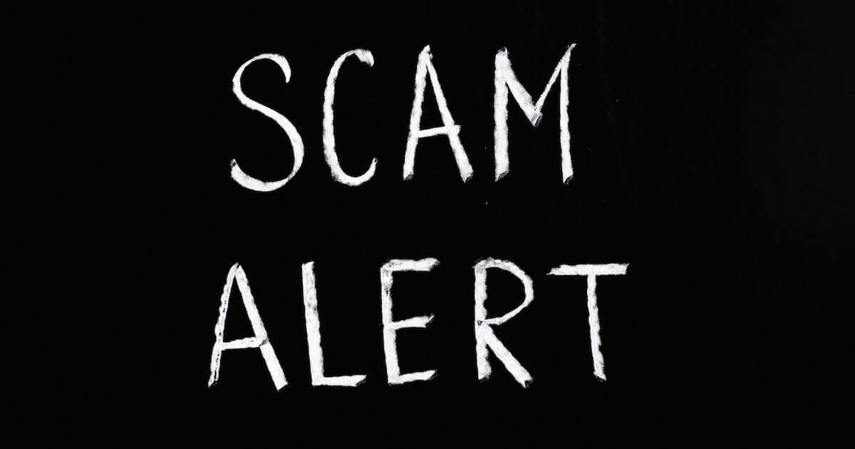 Black background with white text that reads "Scam alert"