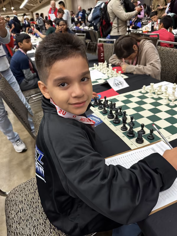 Young student ready for match play at a competitive chess tournament, representing the dedication of RGV  youth players.