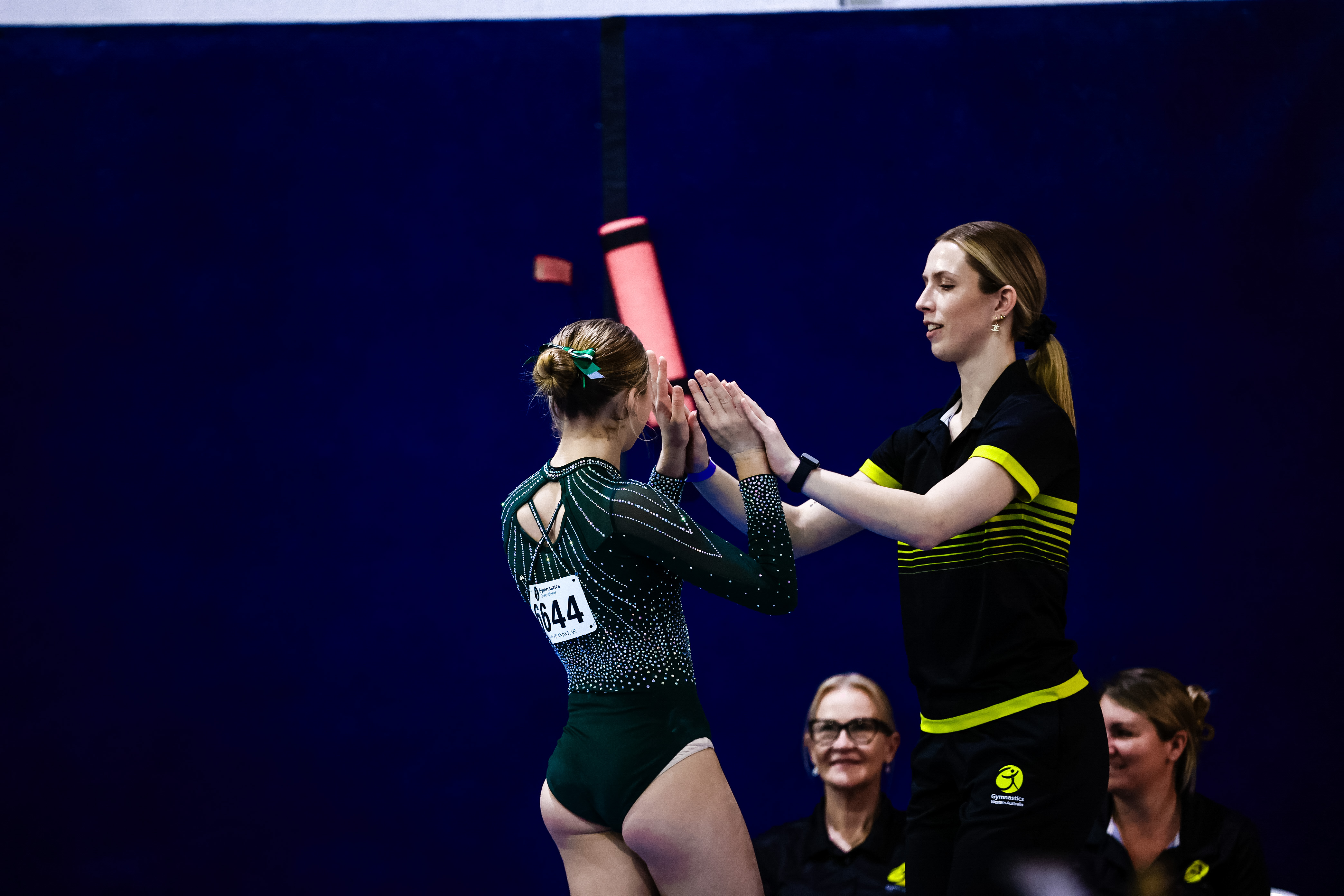 Gymnasts competing at a Gymnastics Queensland event