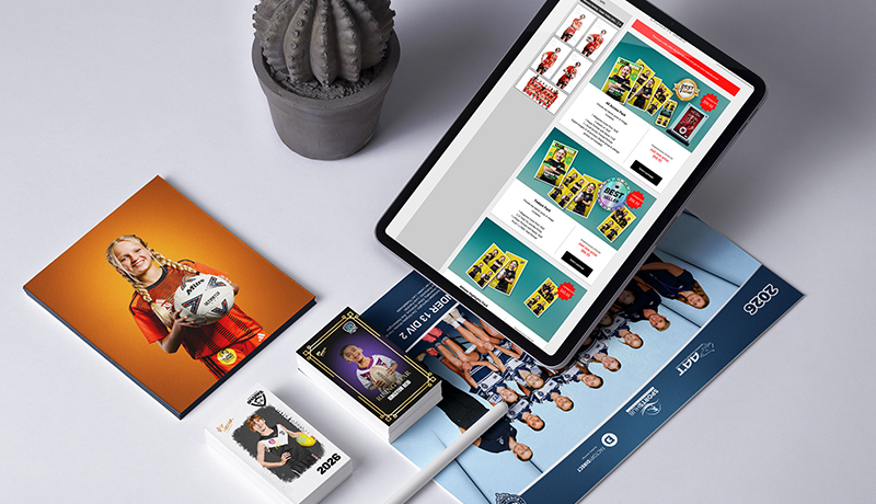Club photo products laid out together: a photo block, player cards, a team poster and an online ordering screen on a tablet