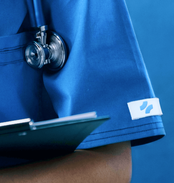 Close-up of a stethoscope on a doctor's blue scrubs