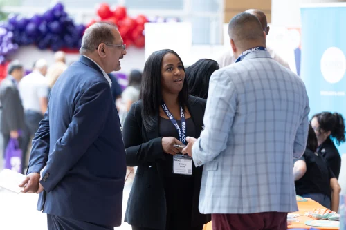 Attendees networking between sessions at the 2025 conference