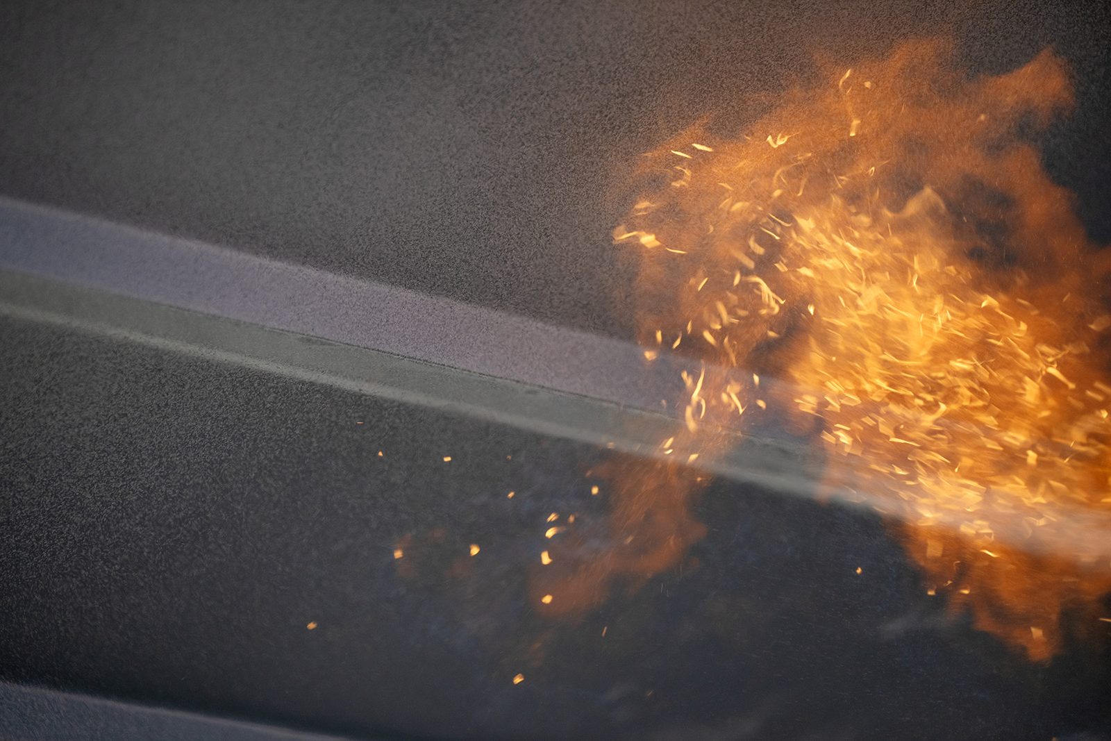 Flame and sparks as the thermopolymer bonds to the hull