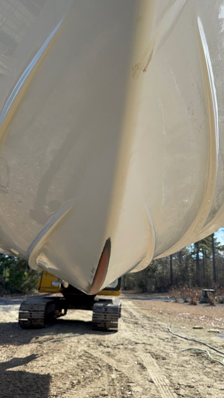 Ken's hull before Aquaphobix™: gel coat worn through along the keel from running on sand