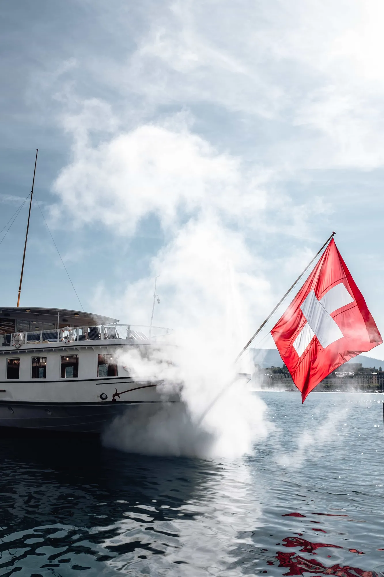 Swiss flag flying against a snow covered mountainside