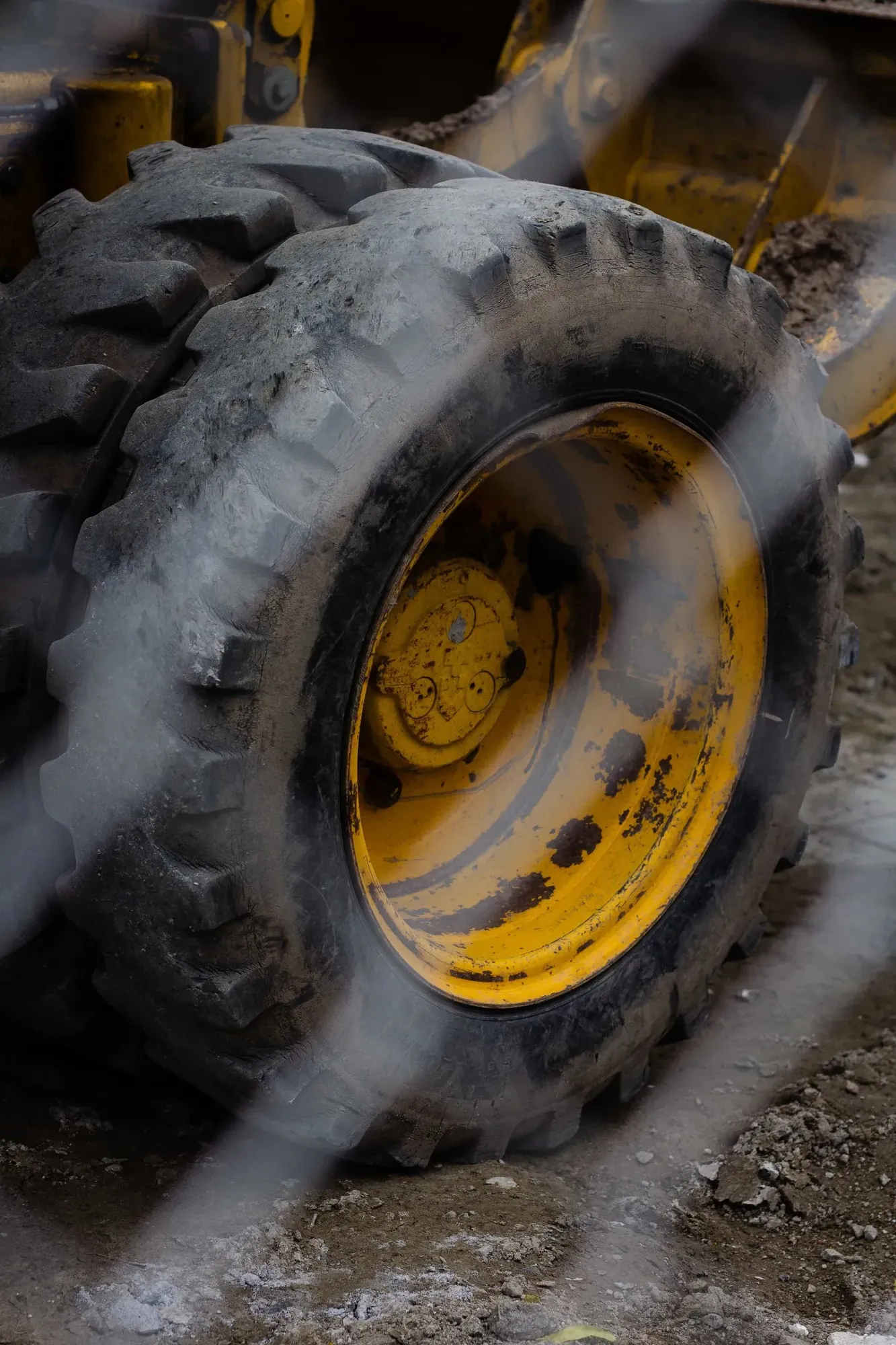Close up of the muddy tyre and wheel rim of a heavy machine