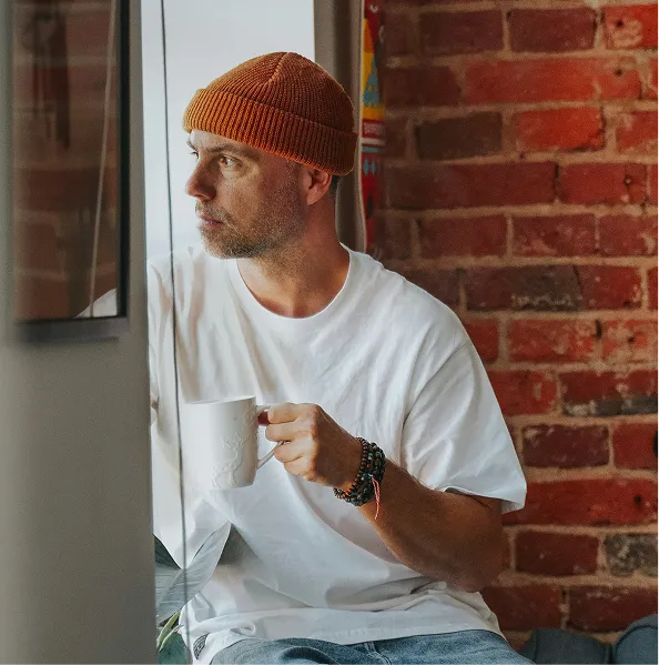 Neighbor holding a warm drink