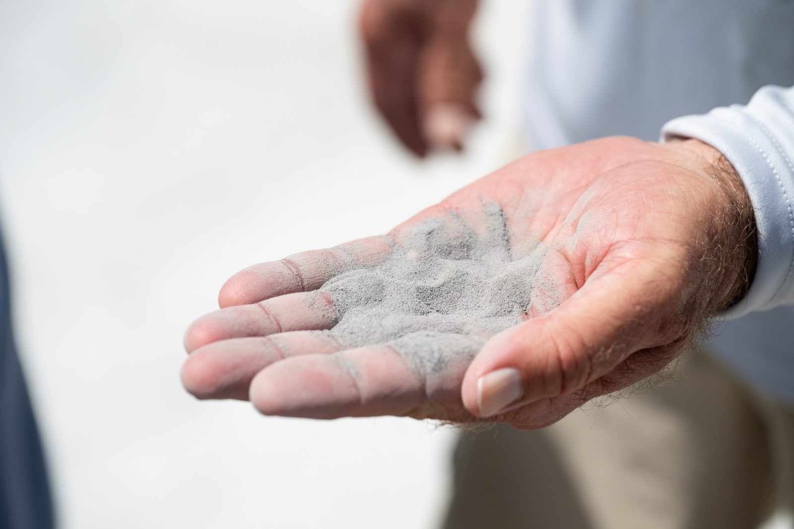 Aquaphobix™ thermopolymer powder in a dealer's hand before application