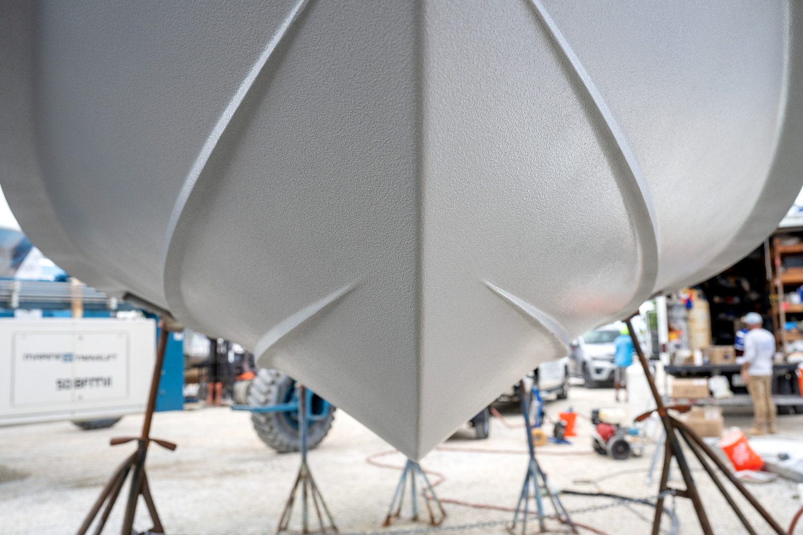 A fiberglass hull on stands, freshly coated with Aquaphobix™