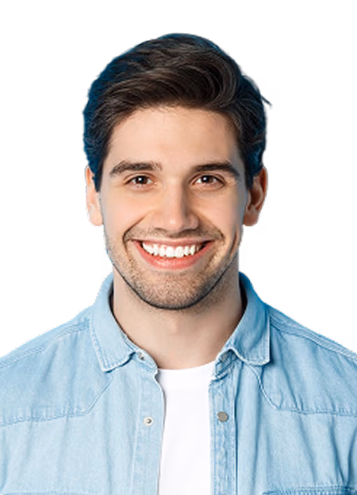 Smiling young man with dark hair wearing a light blue shirt and white t-shirt against a white background.