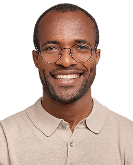 Smiling man with glasses wearing a beige collared shirt against a transparent background.