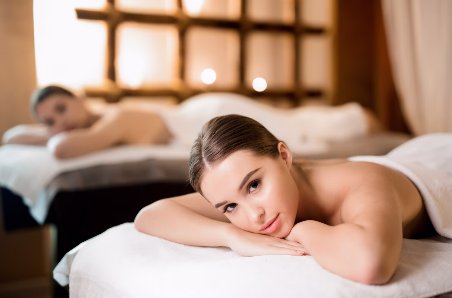 Two clients relaxing on massage tables during a couples massage