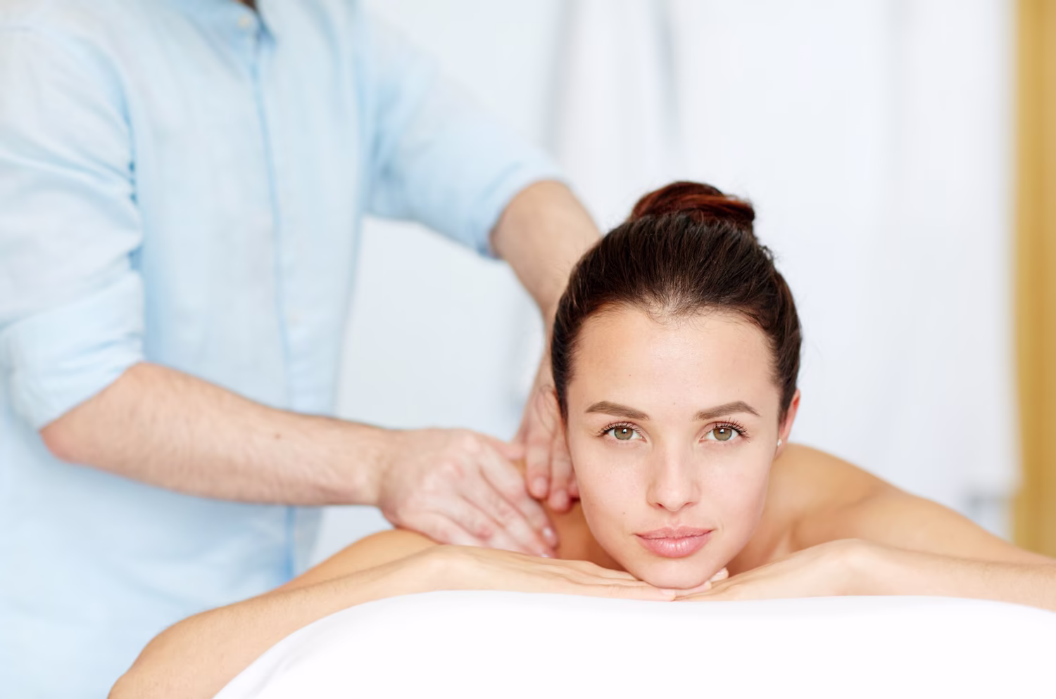 Therapist massaging a woman's shoulders
