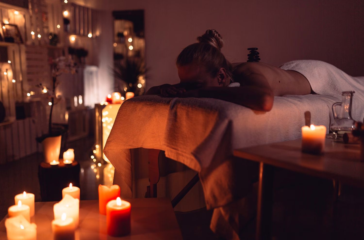 Client relaxing during a candlelit massage session