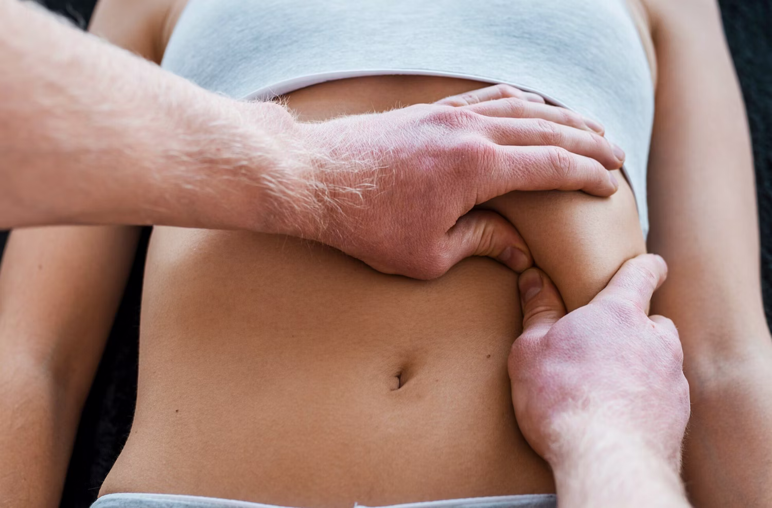 Therapist performing a gentle abdominal massage