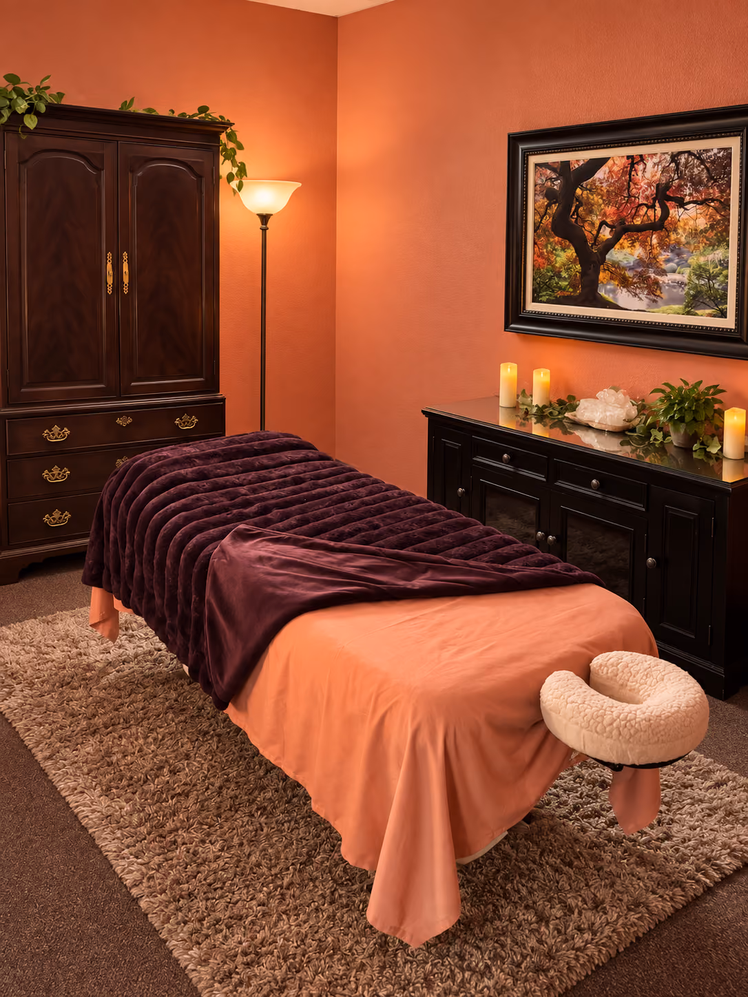 Fire element room with a massage table, candles and warm terracotta walls