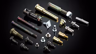 Various metal bolts, screws, and fasteners arranged on a dark reflective surface.