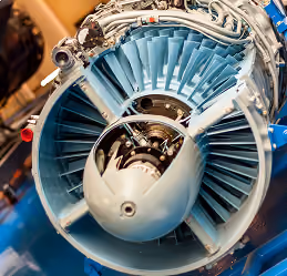 Close-up of an aircraft jet engine showing turbine blades and internal components.