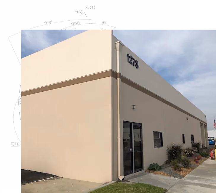 Modern beige industrial building with address number 1273 and a glass entrance door.