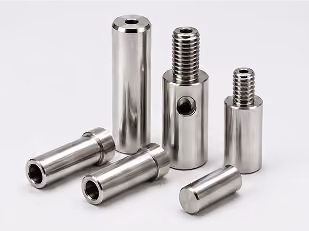 Set of six shiny metal cylindrical machine parts, some with threaded ends and holes.