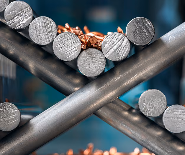 Stack of silver metal rods with a single copper rod in the center.