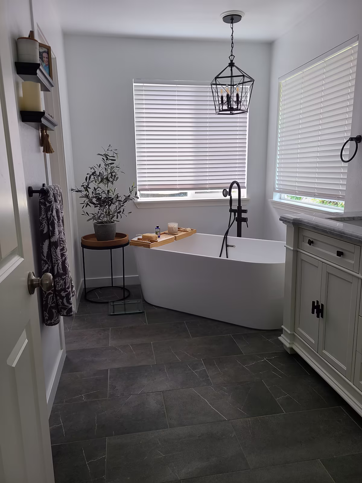 Clean bathroom with a freestanding tub and slate tile floor