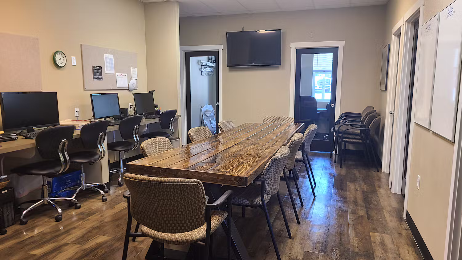 Office workroom with a long conference table and workstations after cleaning