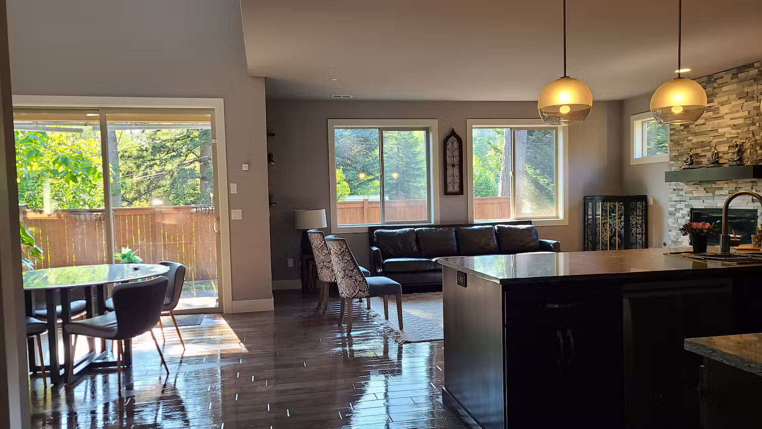Open-plan kitchen and living room with freshly cleaned hardwood floors