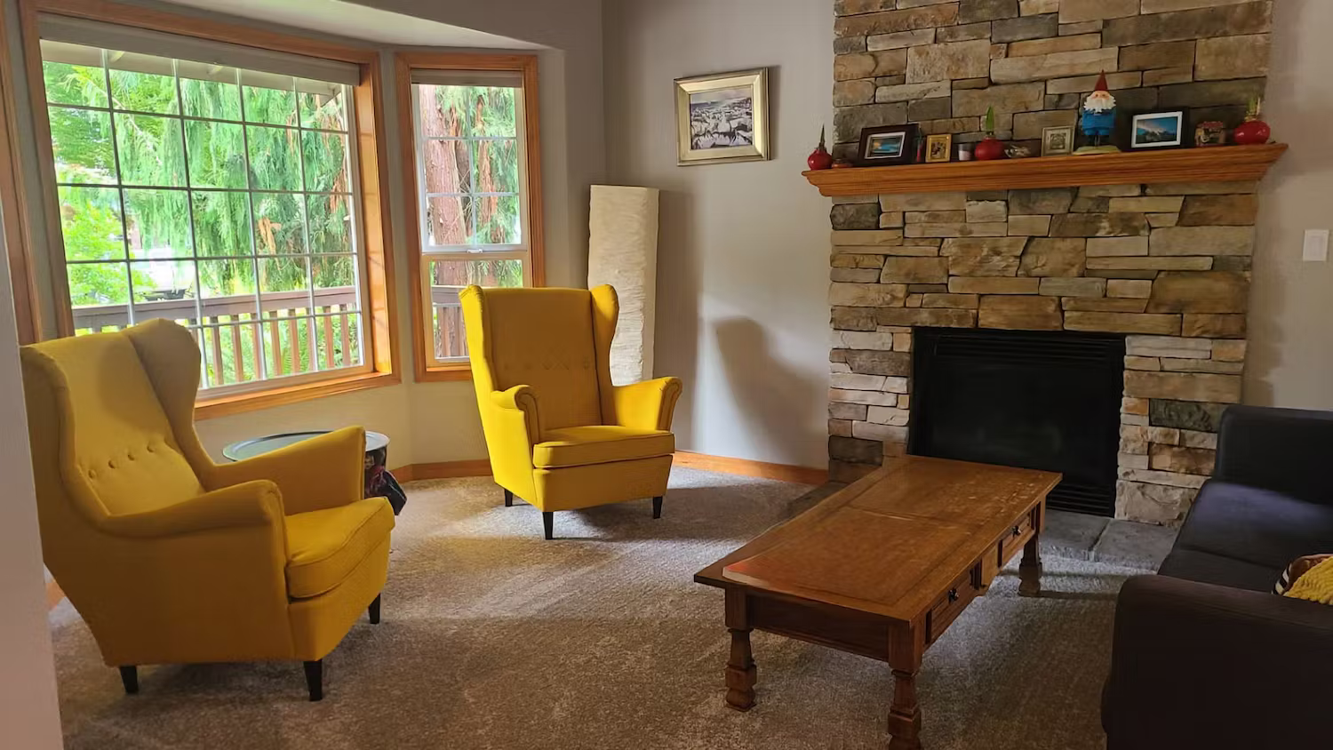 Living room with a stone fireplace after a Klean-It home cleaning