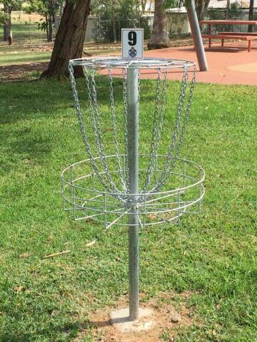 Hole 9 disc golf basket at Charleville Park Golf in Queensland, set on grass beside trees and park facilities.