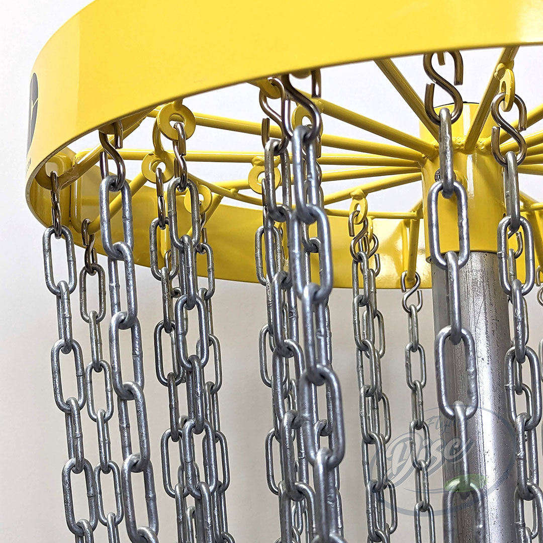 Close-up of the RAD ACE V2 permanent disc golf basket chains hanging from the yellow top assembly.