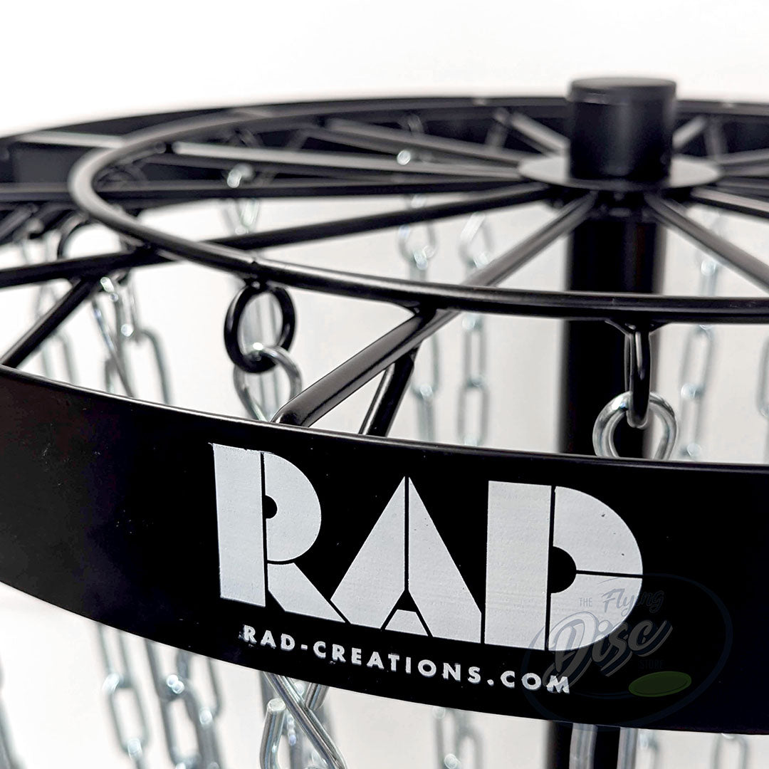 Close-up of the RAD logo printed on the black band of the RAD Birdie Lite disc golf basket.