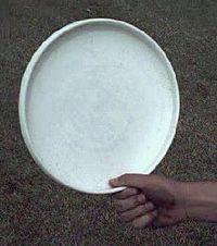A thumber grip on a white disc, the thumb hooked inside the rim.