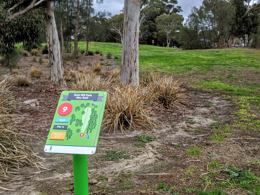 A tee sign for hole 9, par 3, at Bald Hill Park Disc Golf, showing a diagram of the hole.
