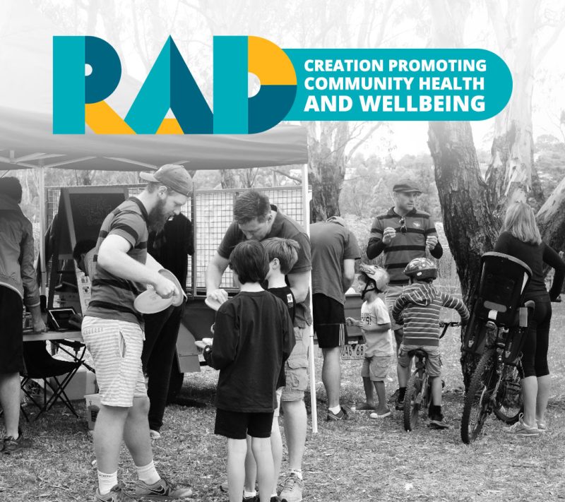 RAD card reading creation promoting community health and wellbeing, over a photograph of a family event.