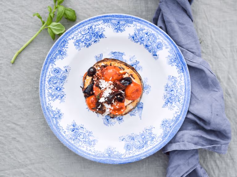 A blue and white plate topped with a dessert