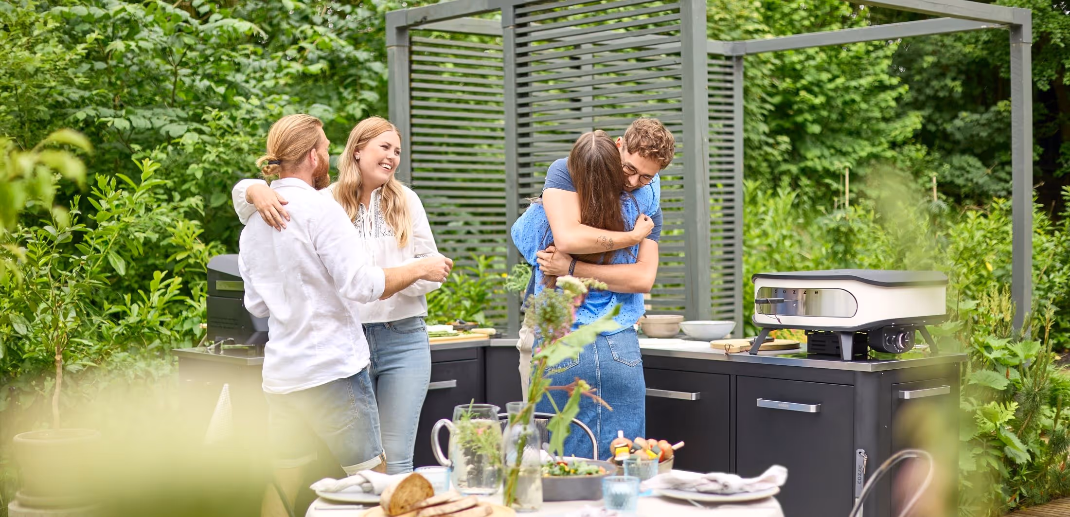 A group of people standing around a table.