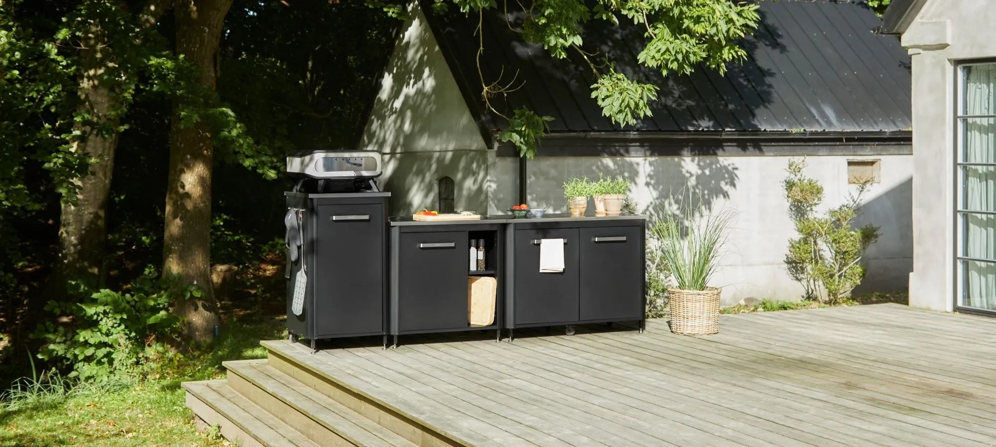 A bbq grill sitting on top of a wooden deck.