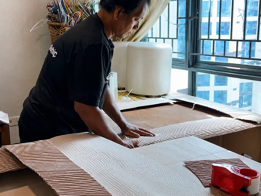 Spaceship mover preparing protective cardboard sheets for furniture packing