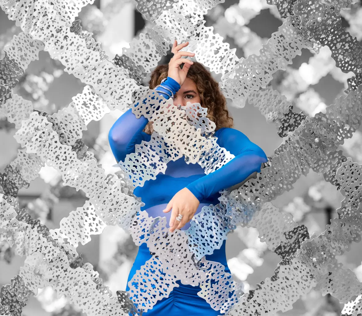 Susana in a blue outfit surrounded by abstract white textured shapes.