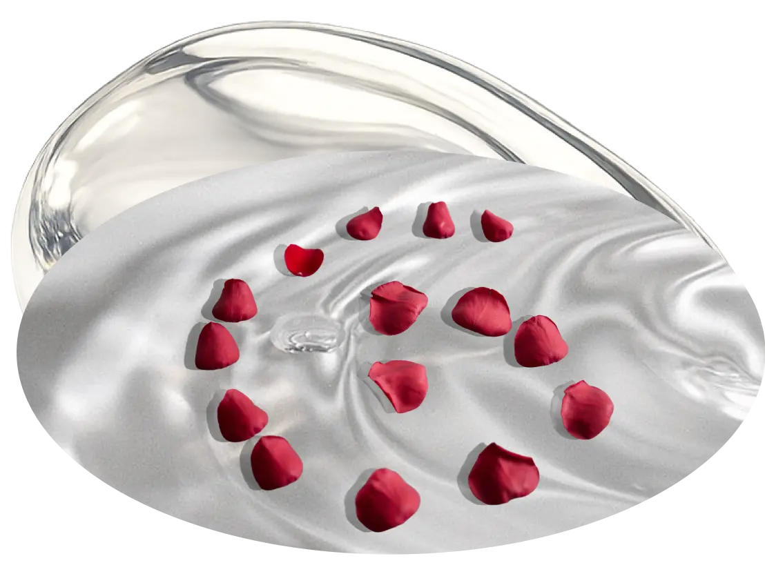 Abstract silver sculpture with red rose petals on a light background.