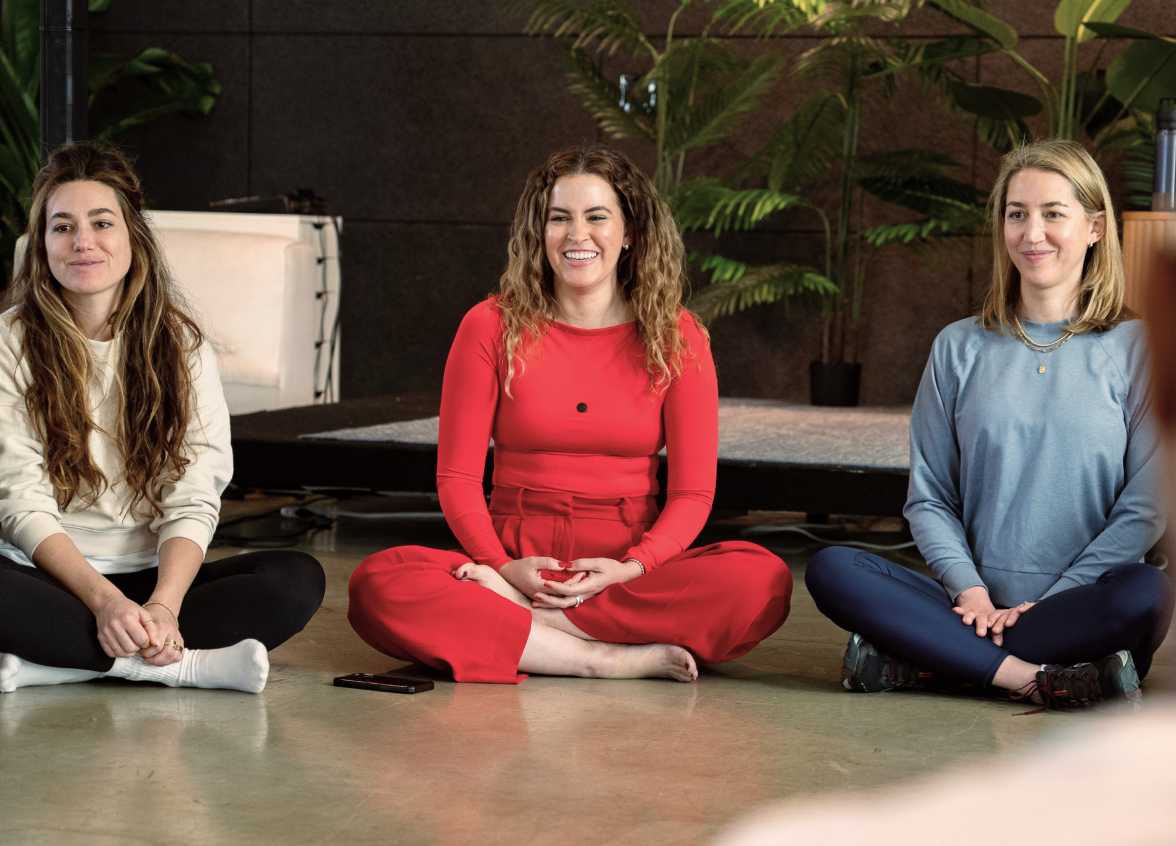 Three women sitting together during a mindfulness session