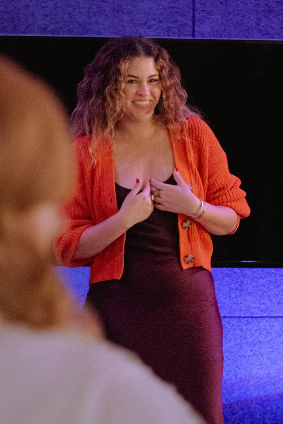 Susana speaking to an audience during a wellness event