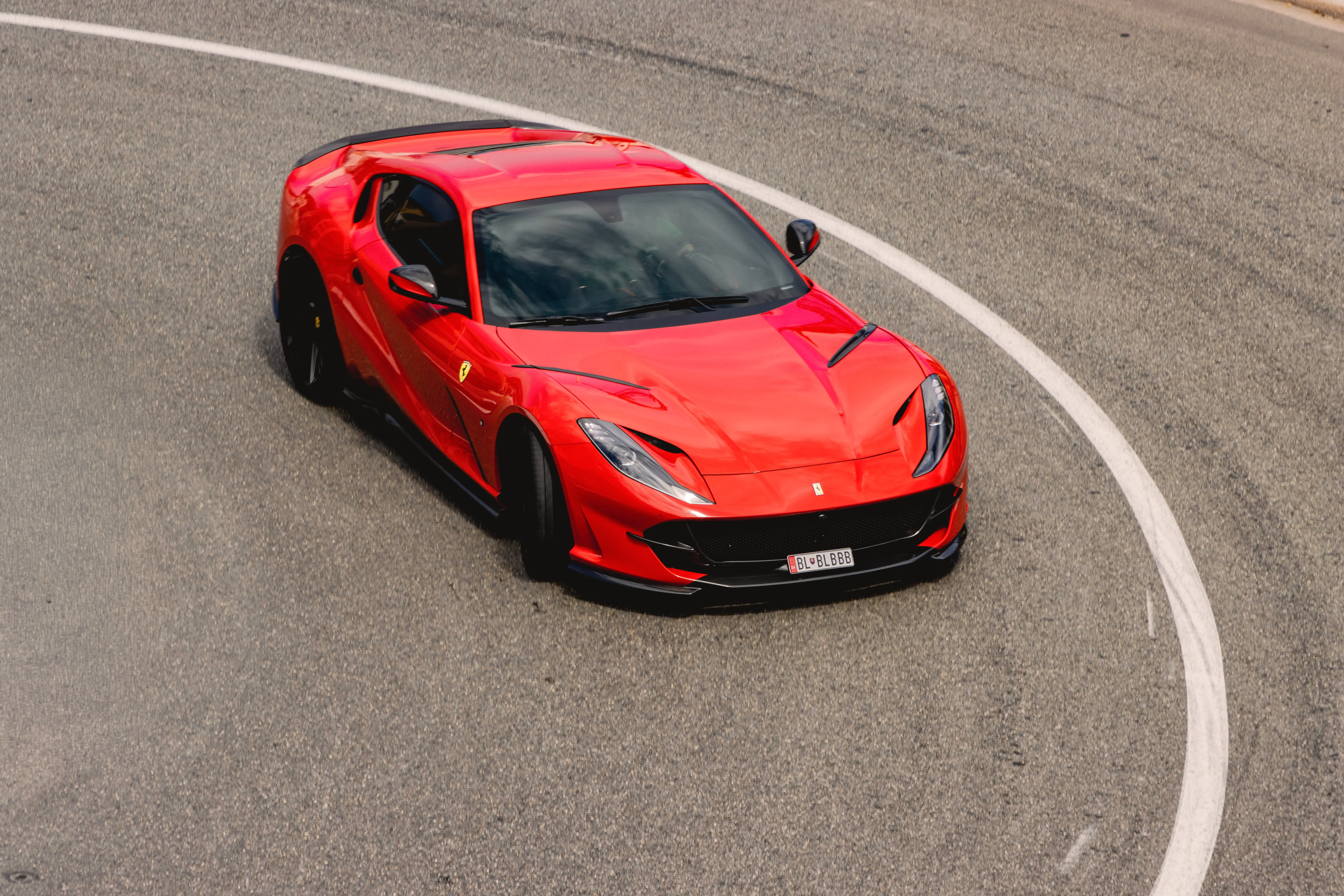 Red Ferrari cornering on a racetrack