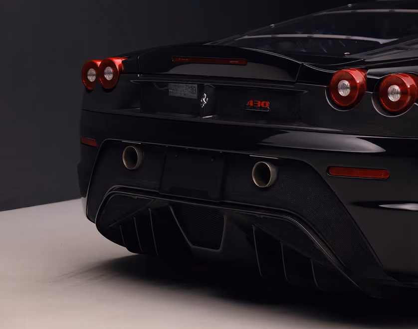 Rear of a black Ferrari in a studio
