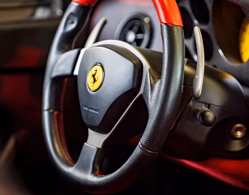 Ferrari steering wheel with yellow Prancing Horse badge