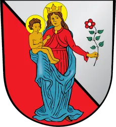 Coat of arms depicting a crowned woman in red holding a child and a flower on a red and silver background.